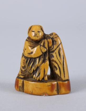 Netsuke of a Man Leaning on a Rock