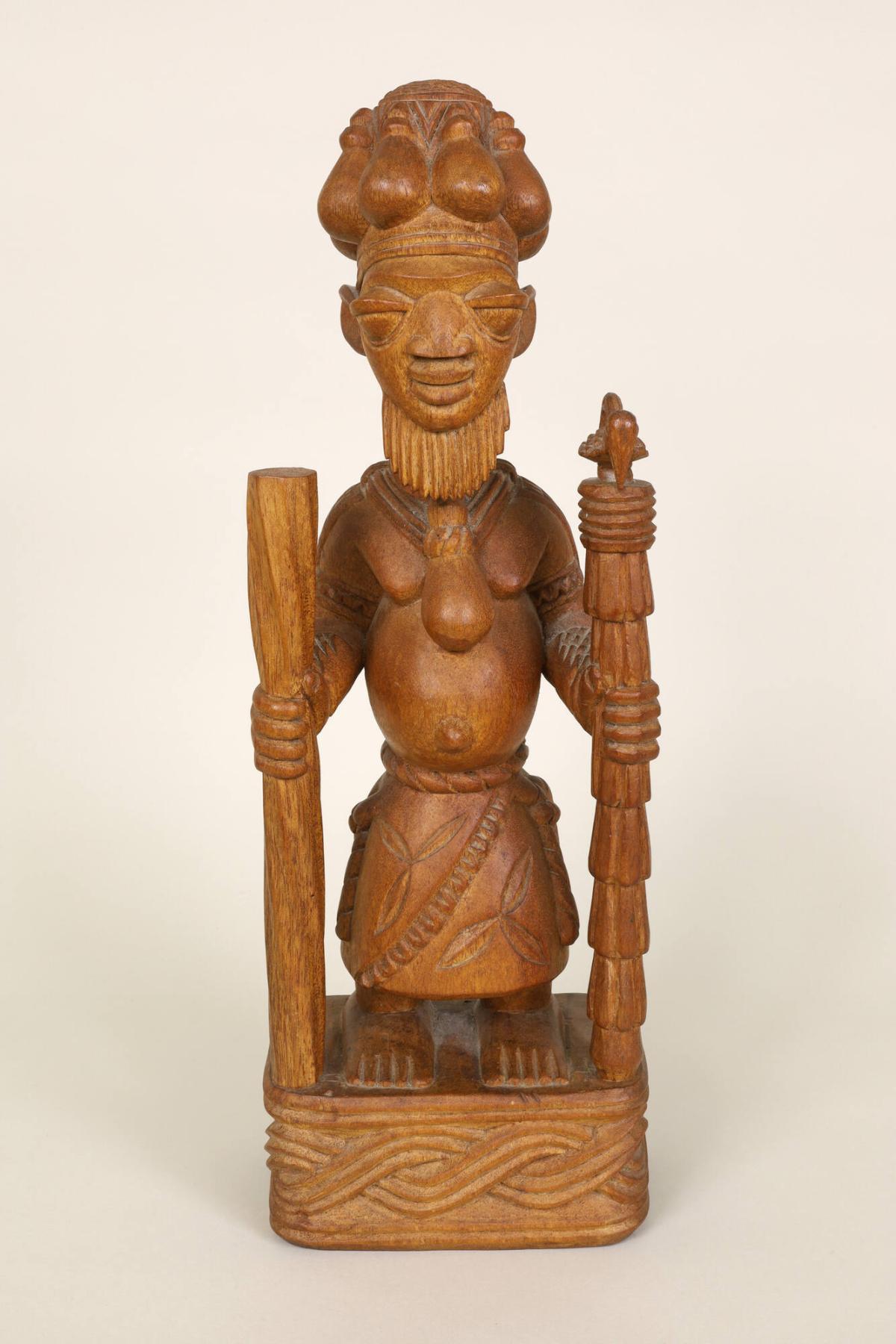 Standing Priest or Shaman Holding Sacred Staffs