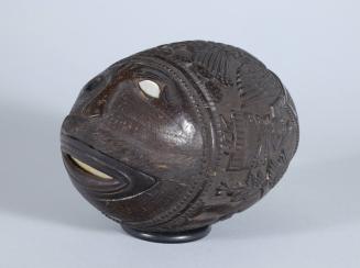 Carved Coconut Bank with Figures and a Face