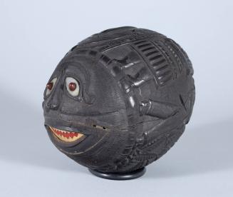 Carved Coconut Bank with Figures and a Face