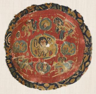 Circular Tunic Medallion Depicting a Figure with Upraised Hands and Nereids