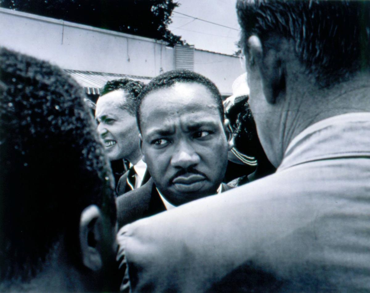 Dr. Martin Luther King Is Confronted: Dr. King is stopped by police at Medgar Evers' funeral, Jackson, Mississippi, June 1963, from the portfolio I am a Man